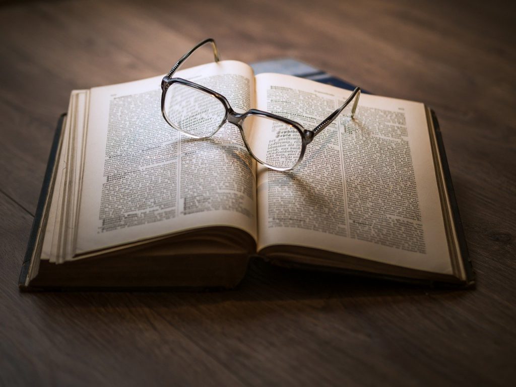Glasses resting on top of an open book